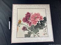 Full frontal image of the painting showing the pink and purple peonies with a bird and Chinese calligraphy, mounted on a brocade mat.