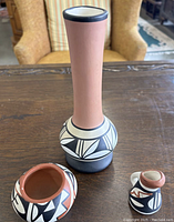 Three Navajo pottery pieces on table showing full front view