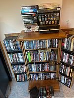Wide view showing multiple shelves filled with DVDs and CDs arranged vertically and horizontally, as well as a display board with IMAX film collection cards.