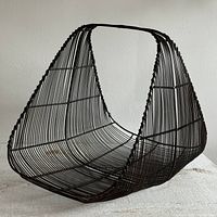 Dark brown wire basket angled view showing curved shape and handle.