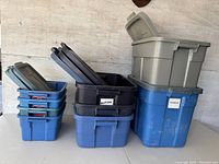 All plastic storage bins stacked and displayed with lids, showing different sizes and colors and labeling.