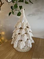Front view of the ceramic Christmas tree showing layered branches and detailed texture
