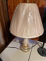 Table lamp with beige pleated fabric shade from front view
