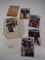 Stack of 1988 OPC hockey trading cards with front of pack visible including a card of a player in black and yellow hockey jersey with '15' visible on the sleeve.
