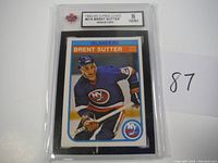 Photo of 1982-83 O-Pee-Chee #216 Brent Sutter rookie card graded 8 NMM by KSA showing front of card in protective slab.