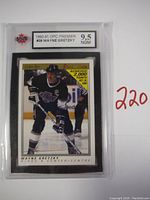 Front of the 1990-91 OPC Premier Wayne Gretzky hockey card showing player in Kings uniform on ice, encapsulated and graded 9.5 NGM by KSA.