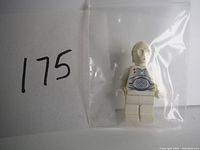 Front view of the vintage LEGO Star Wars C-3PO mini figure in a plastic bag with label 175.