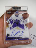 Front view of Erik Kallgren hockey card in hand and case showing autograph and rookie designation