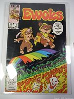 Front view of Ewoks #1 comic book with characters Teebo and Wicket on cover and rainbow bridge with flames below.