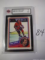 Front view of the 1984-85 O-Pee-Chee Guy Lafleur hockey card graded 7 NM in protective sleeve.