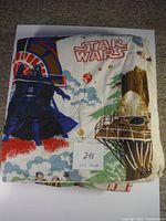 Folded Star Wars comforter showing Darth Vader, treehouse, and Star Wars title.
