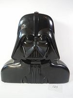 Front view of black plastic Darth Vader shaped carrying case with detailed helmet and chest design.