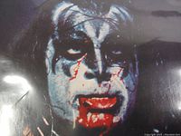 Close-up of KISS band member artwork on album cover showing makeup and theatrical blood.