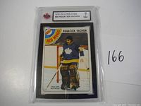 Photo of the front of the 1978-79 O-Pee-Chee Rogatien Vachon hockey card graded 7 NM, showing the player in goalie gear and Red Wings logo.