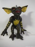 Front view of the 1984 Stripe Gremlin action figure showing detailed paintwork of yellow stripes, silver mohawk, red eyes, and claws.