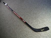 Full view of the Sher-Wood PR1 hockey stick showing length, branding, and wear.
