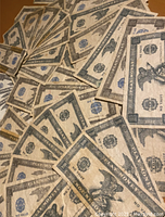 Top view of multiple play paper money pieces spread out showing the design and condition.