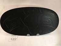 Front view of the black oval-shaped art plate featuring etched Killer Whale design in a traditional First Nations style.