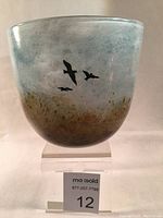 Front angle of the glass bowl showing misty landscape design with birds in flight.