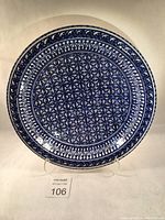 Top view of large hand crafted Tunisian ceramic bowl showing intricate cobalt blue geometric and floral patterns on white ceramic.