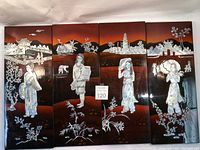 Full set of four lacquer panels showing detailed mother of pearl inlay images of Vietnamese women and traditional buildings on a reddish to black gradient background.