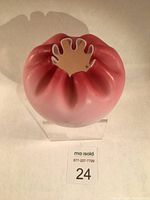 Top view showing crimped, petal-shaped rim with white milk glass interior and gradient cranberry satin glass exterior