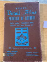 Front cover of Perlys Detailed Atlas Province of Ontario with a maroon textured cover and blue text showing the title and emblem