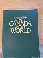 Cover of Hammond Atlas of Canada and the World, showing green hardcover with gold embossed title.