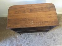 Top view of wooden end table showing natural wood grain and surface wear.