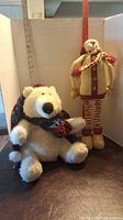 Photo showing side and front of the seated stuffed polar bear and standing tall fabric snowman with a ruler background for size reference.