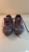 Front view of Saucony XT 500 women's running shoes size 9, showing black and pink mesh design with pink and black laces.