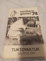 Front cover of the 1974 Northern Games booklet showing a participant in traditional attire at an event in Tuktoyaktuk.