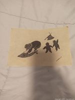 Full view of the Agnes Nanogak stonecut print laid flat on white surface, displaying the entire print and composition.