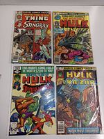 Photo showing all four plastic bagged comics including Marvel Two-in-One #64, Incredible Hulk King Size Annual #8, Marvel Team-Up #97, and Marvel Team-Up #104 with colorful covers and pricing from 40 to 50 cents.