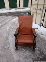 Front view showing seat cushion, armrests, carved griffins