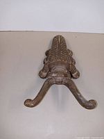 Top view showing the full beetle shape and two curved arms for boot jack function.