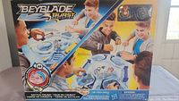 Front of the Beyblade Burst Evolution Battle Tower set box showing product in use and contents.