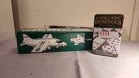 Photo showing Hess model plane and jet boxes alongside Double Nine Dominoes box.