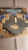 Front view of Kinkajou bottle cutter in packaging showing tool and blue handles.
