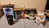 Photo of all items: digital counting money jar, sort bank, Chia Pet, Moo Mixer, secret camera