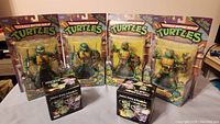 Four Teenage Mutant Ninja Turtles action figures in sealed packages with original colorful backing cards