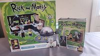 Front view of the two boxed Rick and Morty construction sets showing the larger Spaceship and Garage set and smaller figure scene set.