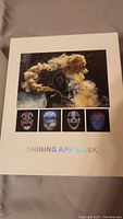 Box cover image showing the shining app mask with LED effects and several glowing face designs.