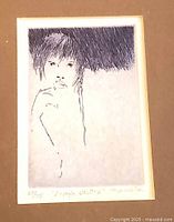 Framed monochrome sketch showing a person with dark hair and shaded background.