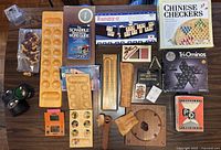 Overall top-down image showing all game components including wooden boards, boxed games, and handheld Nintendo Donkey Kong game