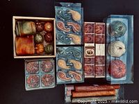 Boxed autumn-colored pillar candles, faux gourds, paisley wax melts, and potpourri sticks.