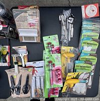 Overview of kitchen gadgets showing meat tenderizers, cut resistant gloves, corers, peelers, and sharpeners mostly in original packaging.
