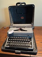 Front view of antique Royal typewriter inside black carrying case, showing keyboard and part of case.