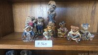 Wide view of 7 Boyd's Bears and Friends figurines arranged on shelf showing full set and details.