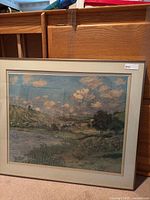 Front view of the framed Monet Claude facsimile landscape print in mat and frame, showing a river with landscape and cloudy sky.